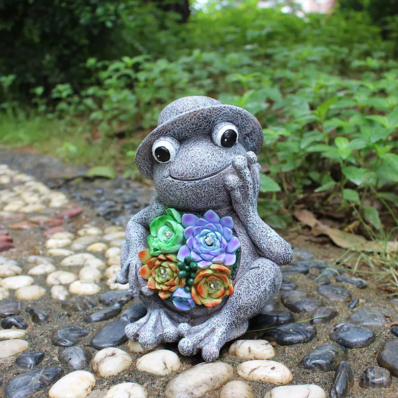 Frog Garden Statue with Solar LED Lights placed among garden plants