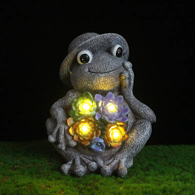 Close-up of Frog Garden Statue with Solar LED Lights glowing at night