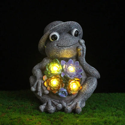 Close-up of Frog Garden Statue with Solar LED Lights glowing at night